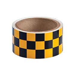 a roll of black and yellow checkered tape