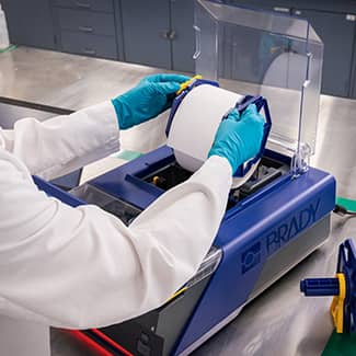 A lab tech quickly reloading the J7300 printer with new label material.