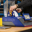 A person inserting a J7300 label cartridge with confidence.