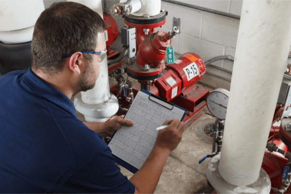 LOTO procedure review by a worker with a clipboard